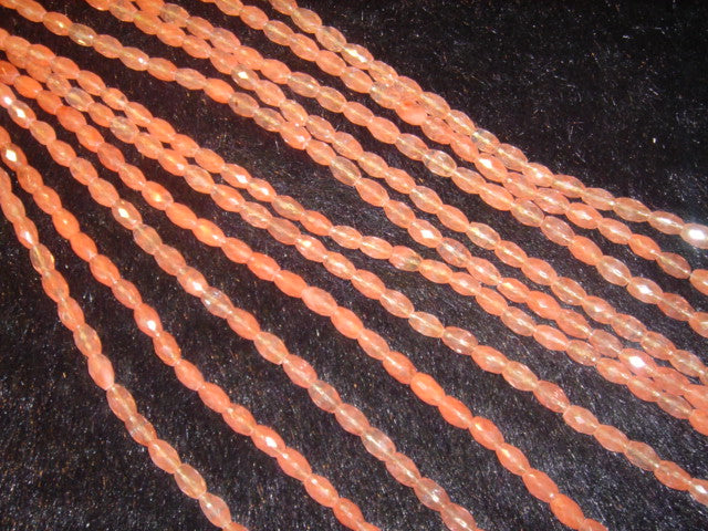 6mm x 9mm Faceted Oval Rice Cherry Quartz (Dyed) – ambient